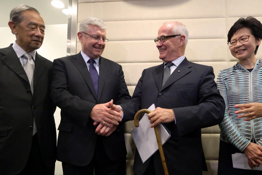 Duncan Pescod (second from left) shakes hands with Michael Lynch yesterday as Ronald Arculli and Carrie Lam look on. Photo: Sam Tsang