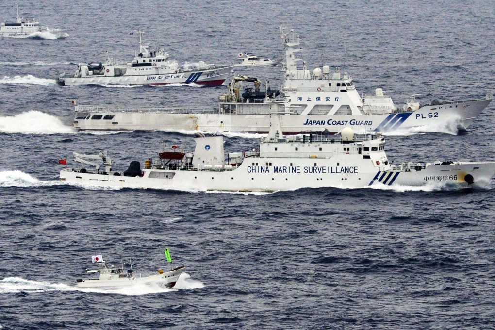 An aerial photo shows a Chinese marine surveillance ship Haijian No. 66 (C) cruising next to Japan Coast Guard patrol ships in the East China Sea. Photo: Reuters
