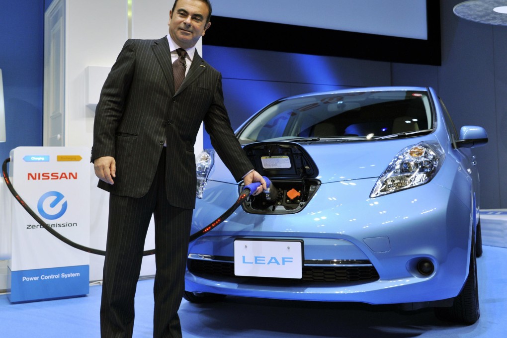 Carlos Ghosn with a Nissan Leaf electric car. Photo: AFP