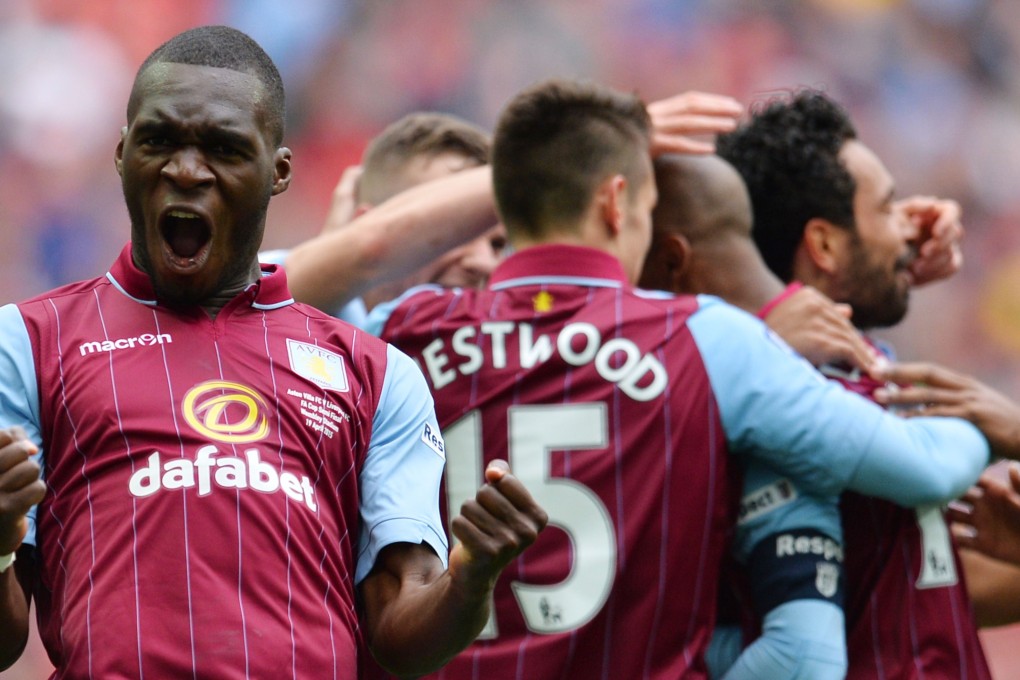 Christian Benteke celebrates Villa's second goal against Liverpool in the FA Cup in April. Photo: AFP