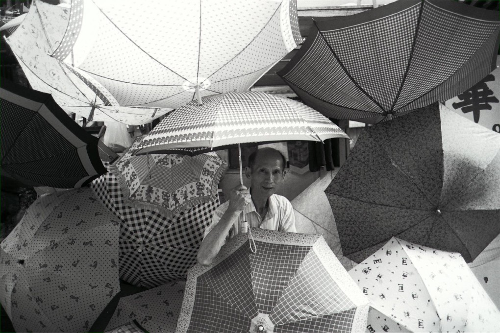 Ho Hung-hee surrounded by his beloved umbrellas at his repair stall in Central that he operated for over half a century.Photo: SMP Pictures
