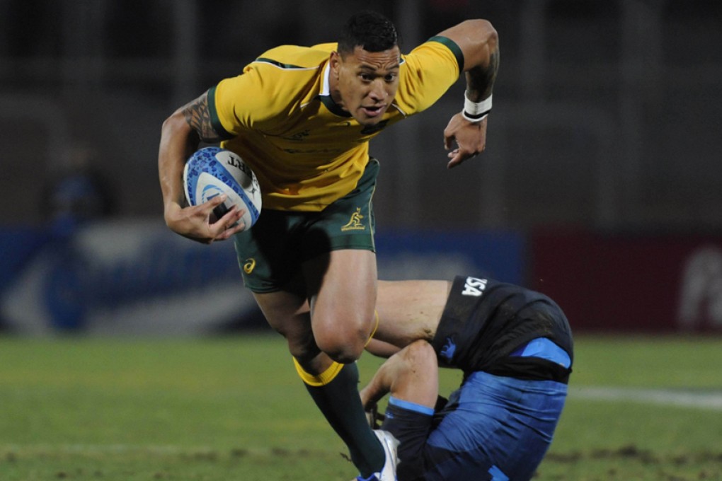 Israel Folau slips a tackle from Argentina’s Juan Imhoff during Australia’s 34-9 Rugby Championship victory in Mendoza on Saturday. Photos: AFP