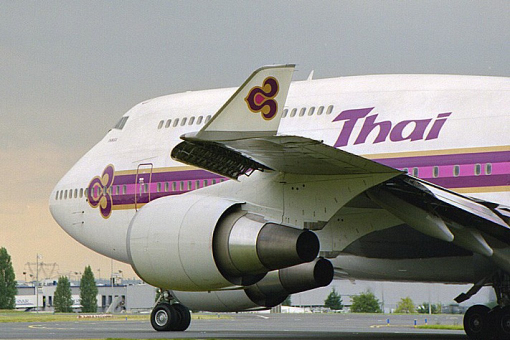 A thai Airways jet preparing for take-off as the company announced jobs cuts and suspended flights to the US. Photo: Handout