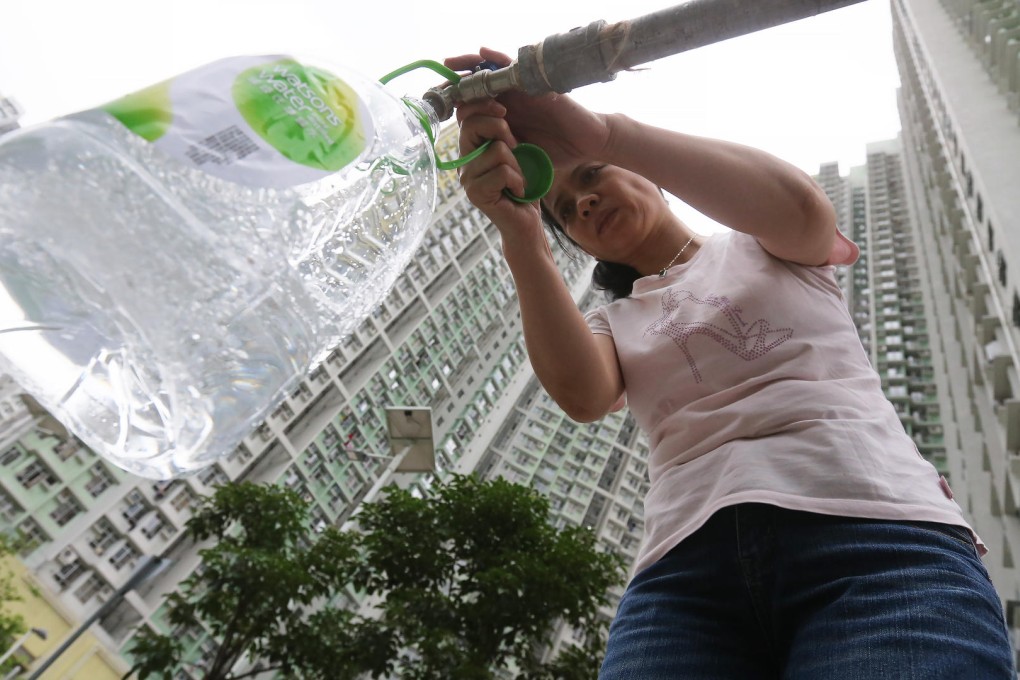 Residents collect fresh water at one of the temporary distribution points set up on the Kai Ching Estate. Photo: Dickson Lee