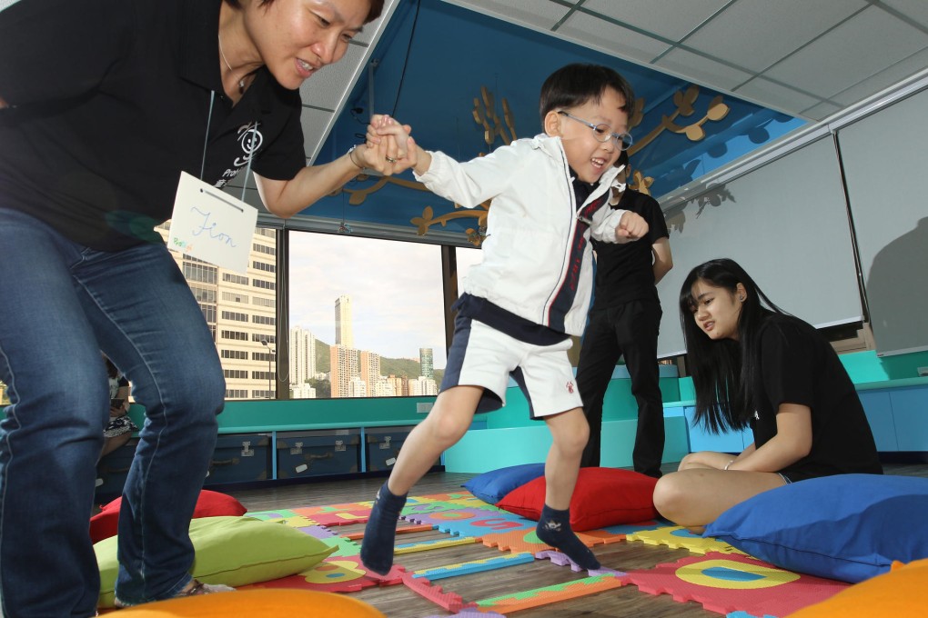 Fion Lui (left), founder of Protege, takes young Kyle Chan through a guided play session. Photo: Franke Tsang
