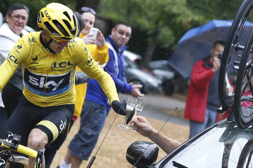 Britain's Chris Froome enjoys the traditional toast of champagne on the last stage of the Tour de France into Paris on Sunday. Photos: AP