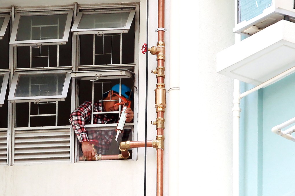 A worker install a new water pipe at Kai Ching Estate. Photo: May Tse