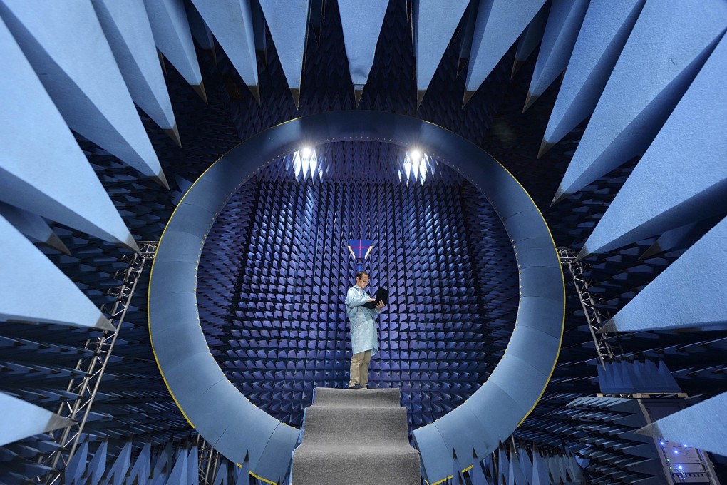 An employee conducts tests at an antenna near field, at a factory of FiberHome Technologies Group, in Wuhan, Hubei province. China's net assets reached 352.2 trillion yuan in 2013, the Chinese Academy of Social Science says. Photo: Reuters