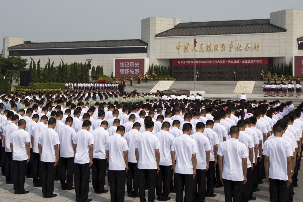 Chinese soldiers and students bow during a commemoration service outside the Museum of the War of Chinese People's Resistance Against Japanese Aggression, in Beijing. Photo: AP