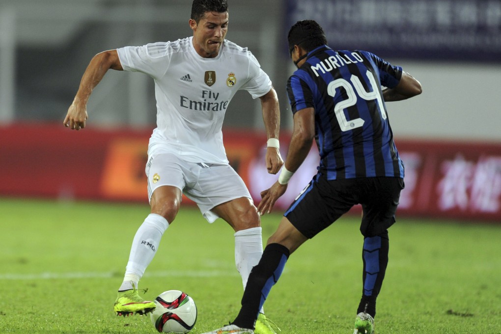 Cristiano Ronaldo vies for the ball as Real Madrid go on to beat Inter Milan 3-0 during their International Champions Cup football match in Guangzhou in southern China's Guangdong province on Monday. Photo: AP
