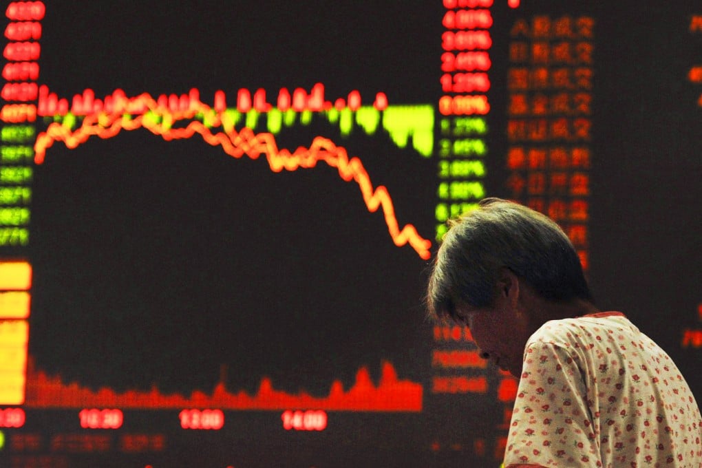 An investor stands in front of an electronic board showing stock information at a brokerage house in Qingdao. Photo: Reuters