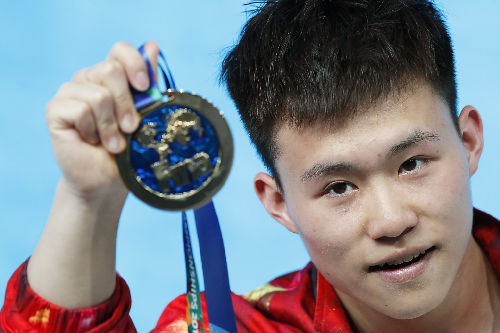 Teenager Xie Siyi with his gold. Photo: EPA