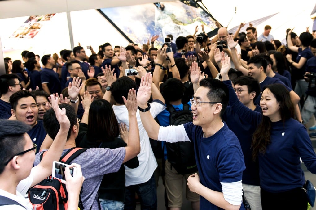 Employees welcome customers into Appl's new Canton Road store in Tsim Sha Tsui, Hong Kong. Photo: Bloomberg