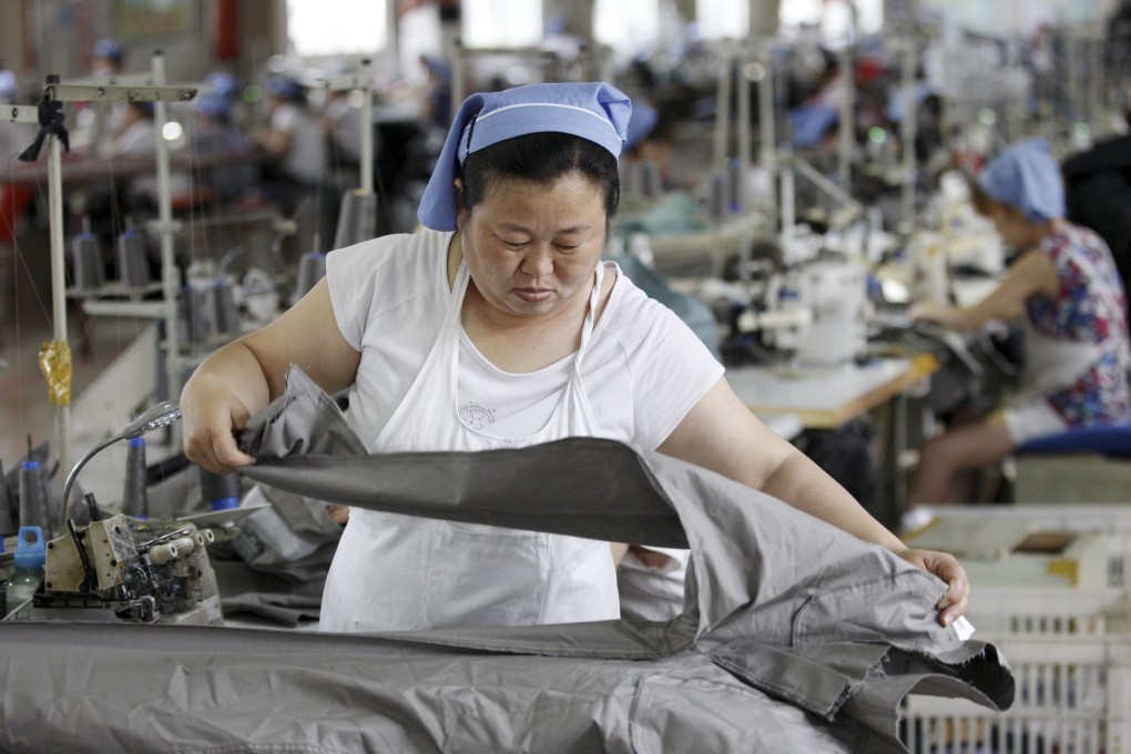 A woman works at a garment factory in Huaibei in central China's Anhui province Wednesday, July 15, 2015. China's economic growth in the latest quarter held steady at 7 percent, its weakest performance since the global crisis, but better retail sales and factory output in June suggested efforts to reverse the slump might be gaining traction. (Chinatopix via AP) CHINA OUT