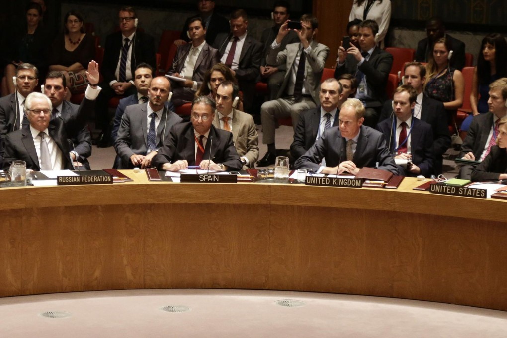 The Russian Ambassador to the United Nations, Vitaly Churkin (left), votes by himself during the UN Security Council vote. Photo: EPA