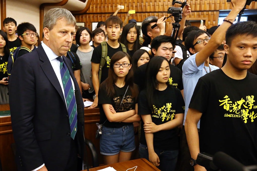 University vice-chancellor Peter Mathieson is surrounded by students after they stormed the council meeting. Photo: Dickson Lee