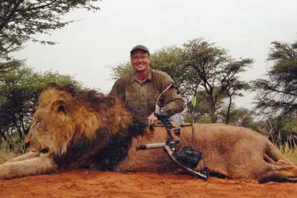 American James Palmer, who is wanted for the killing of the famous lion Cecil in Zimbabwe, sits beside a previous kill. Photo: SCMP Pictures