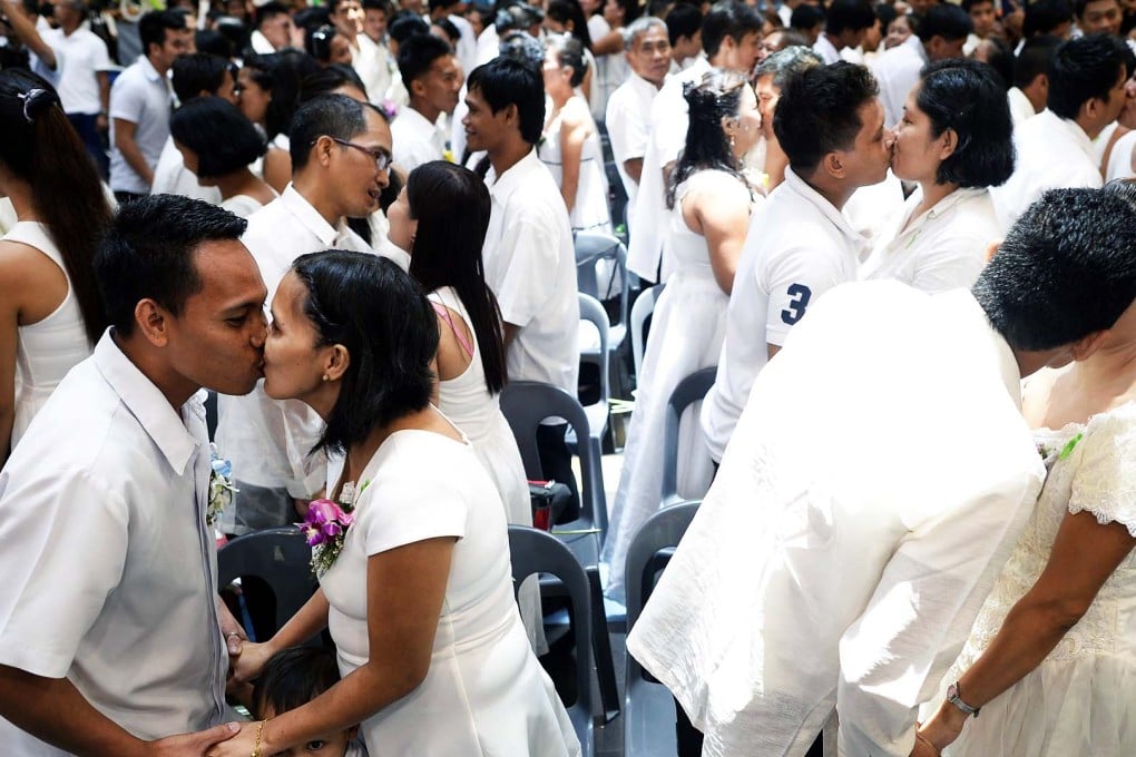 A mass wedding is held inside a shopping center in Manila. With their functions expanding from shopping and dining to venues for Catholic mass, Zumba workouts or even weddings, experts say malls are taking on a more important role at the heart of communities. Photo: AFP