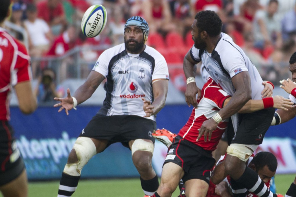 Malakai Ravulo offloads to Tevita Cavubati as he is tackled during Fiji’s 27-22 Pacific Nations Cup victory over Japan in Toronto on Wednesday. Photos: AFP