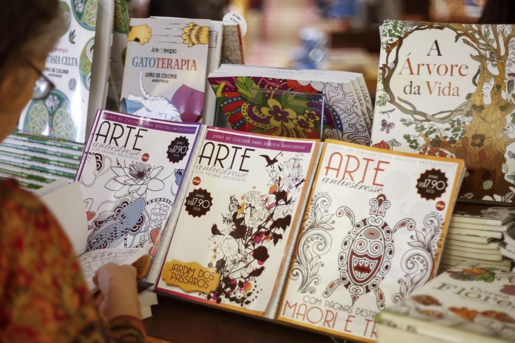 A woman examines colouring books in Sao Paulo, Brazil. More than a million such books have been sold in the country. Photos: AFP, AP