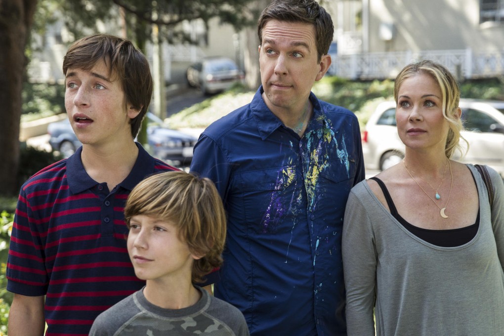 Christina Applegate as Debbie and Ed Helms as Rusty, with sons James (Skyler Gisondo) and Kevin (Steele Stebbins).