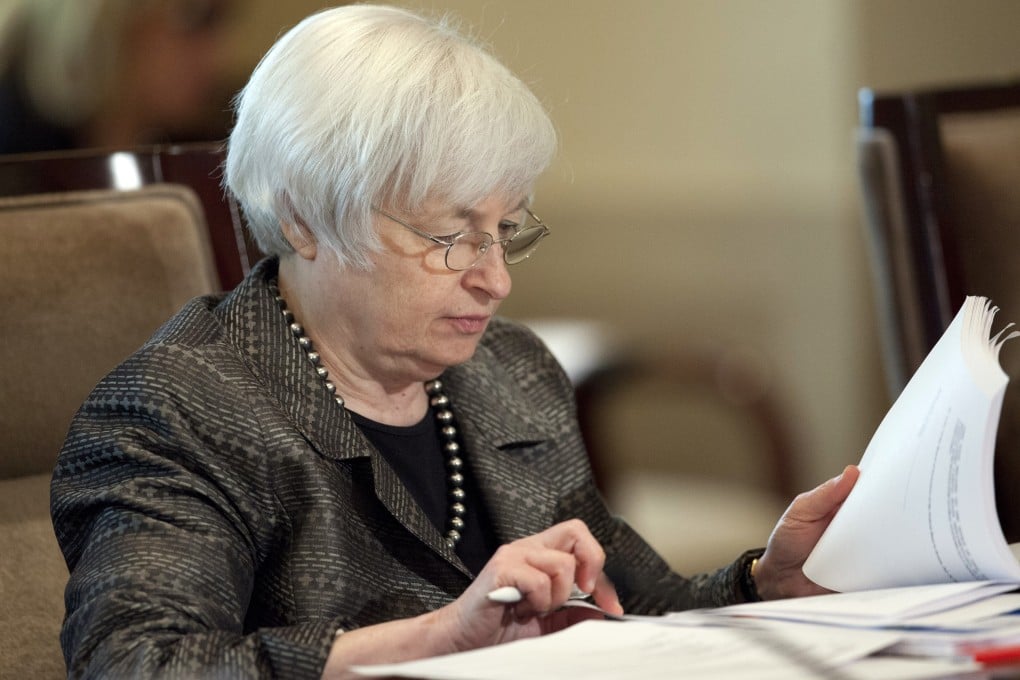 Federal Reserve chair Janet Yellen leafs through a report as the US central bank sees balanced risks to the economy and analysts feel this would be no bar to raising rates in September. Photo: AP