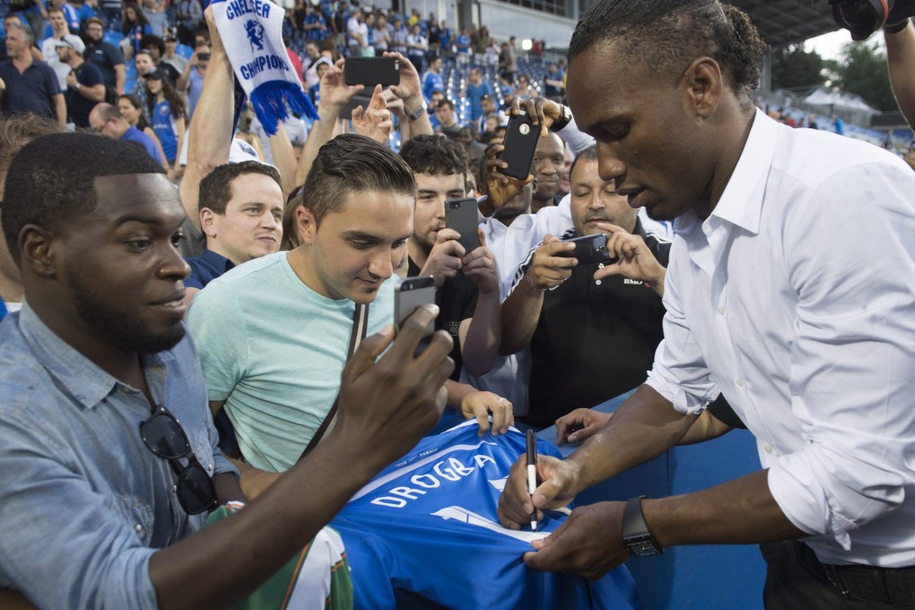 Didier Drogba signs autographs. Photo: AP