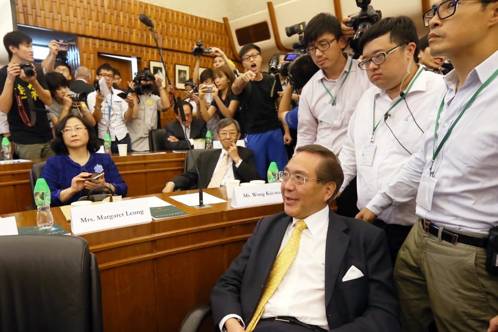A student protester gesticulates at University Council member Professor Arthur Li Kwok-cheung after dozens stormed a council meeting this week. Photo: Dickson Lee