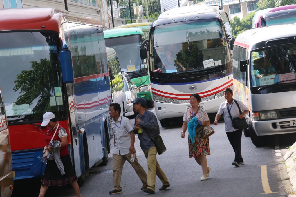 A tourist bus drops off passengers at Beard Road in Repulse Bay. The tourist influx is seen to have had an impact on the area's character. Photo: David Wong