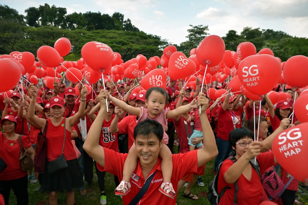 A toddler gets a celebratory lift from her father in a Singapore park. Photos: SMP Pictures