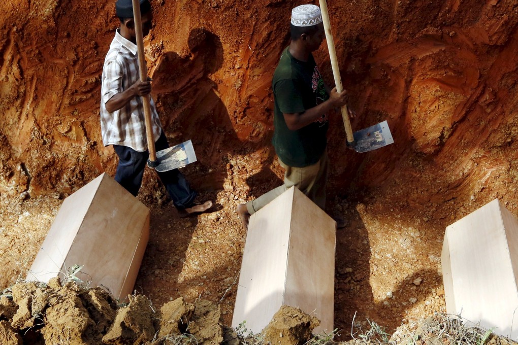 Coffins lie in a mass grave of unidentified Rohingya remains found at a traffickers camp in Wang Kelian, at a cemetery near Alor Setar, Malaysia. Photo: Reuters