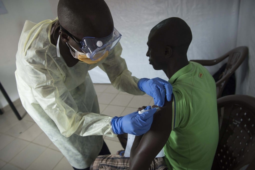 A volunteer Ebola frontline worker receiving the rVSV-EBOV experimental vaccine. Photo: EPA