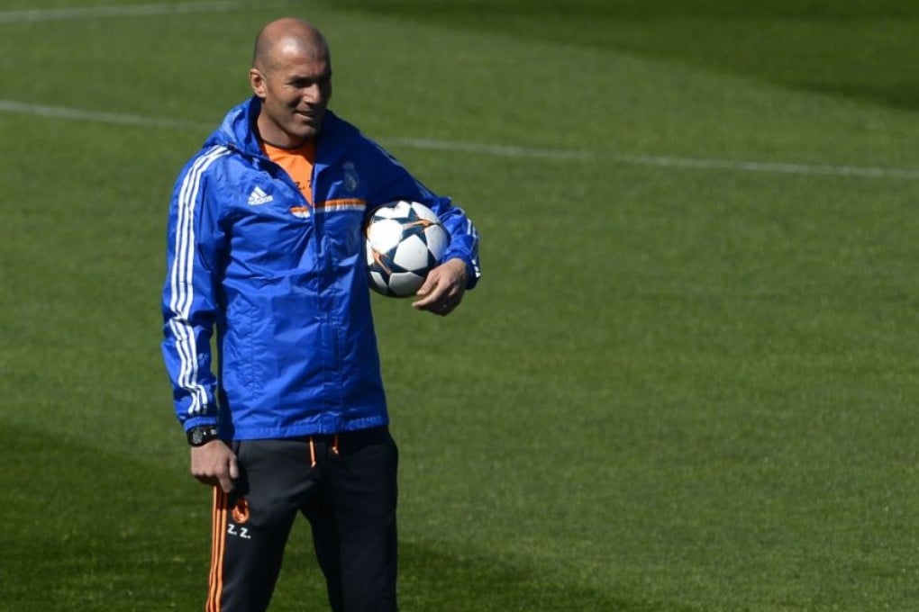 Former France and Real Madrid footballing great Zinedine Zidane gives us a taste of what’s to come as he tucks a round ball under his arm and looks towards the “try-line”. Photo: AFP