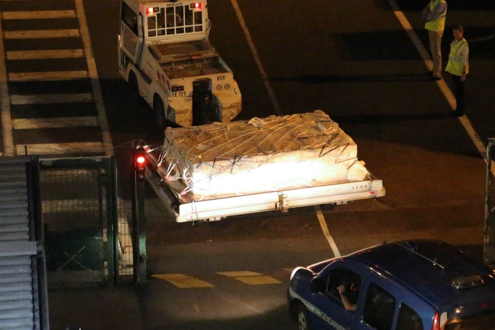 Police officers escort an airport vehicle transporting the debris from a Boeing 777 plane that washed up on the Reunion Island. Photo: AFP