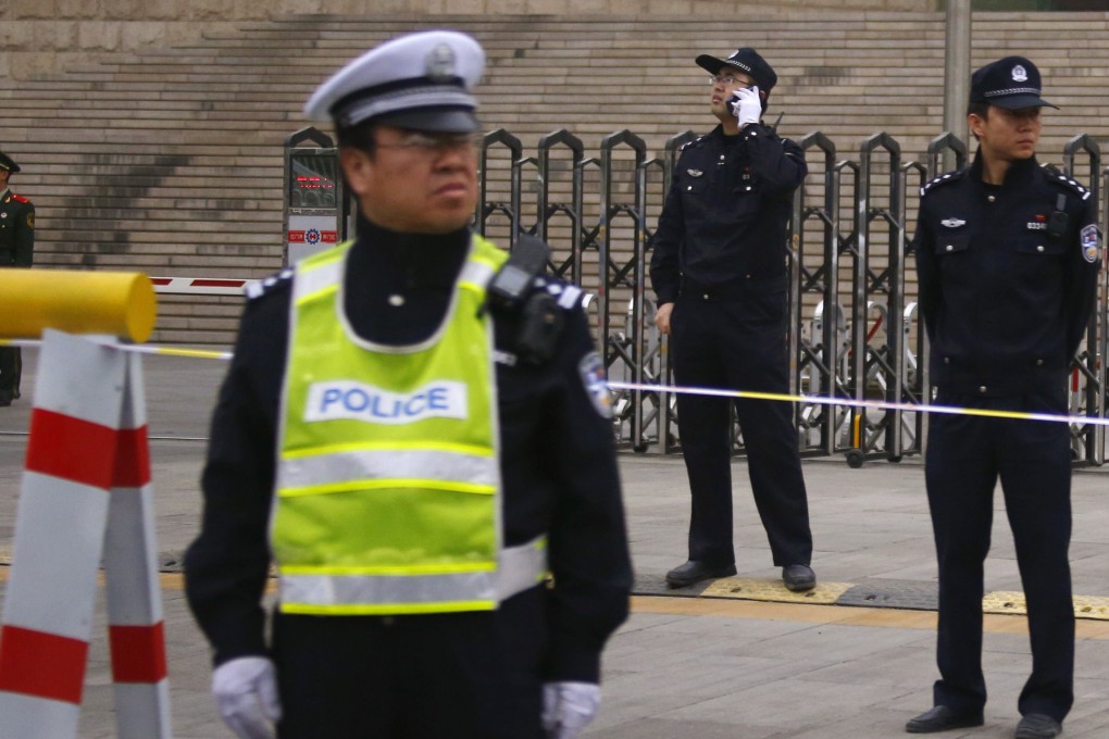 Police officers stand guard outside a Beijing court during a Chinese rights activist's hearing last year. Photo: Reuters