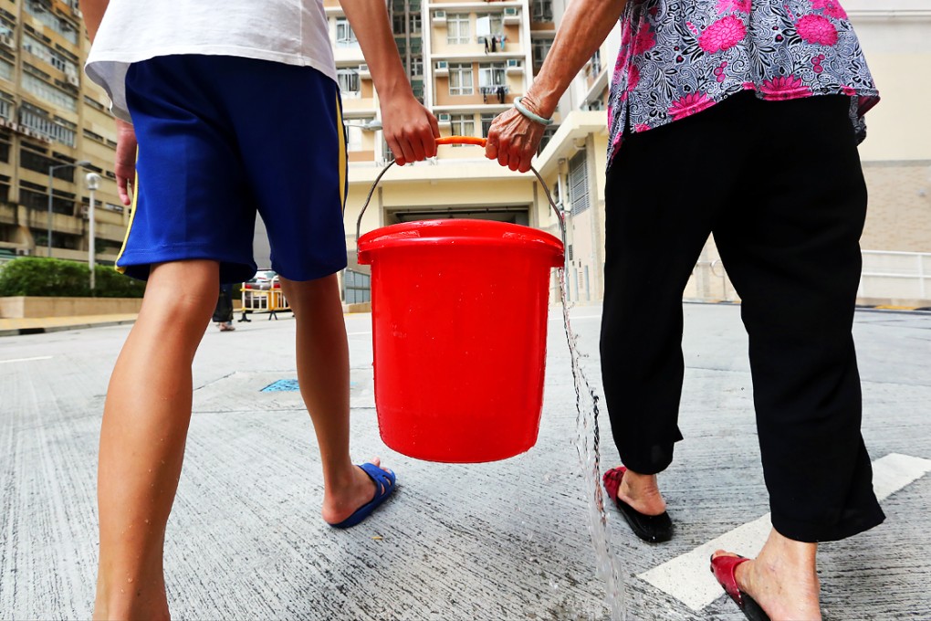 Residents collect fresh water at one of the temporary distribution points at Hung Hom Estate in Hung Hom. Photo: Sam Tsang