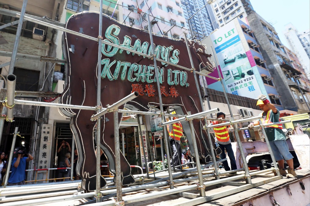 Workers remove the neon sign at Sammy's Kitchen before it is sent to the M+ visual arts collection. Photo: K. Y. Cheng