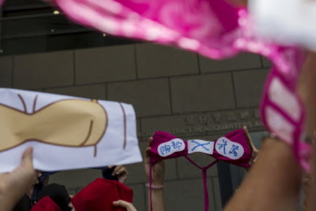 A protester holds up a bra with a sign during a demonstration in support of protester Ng Lai-ying. Photo: Reuters