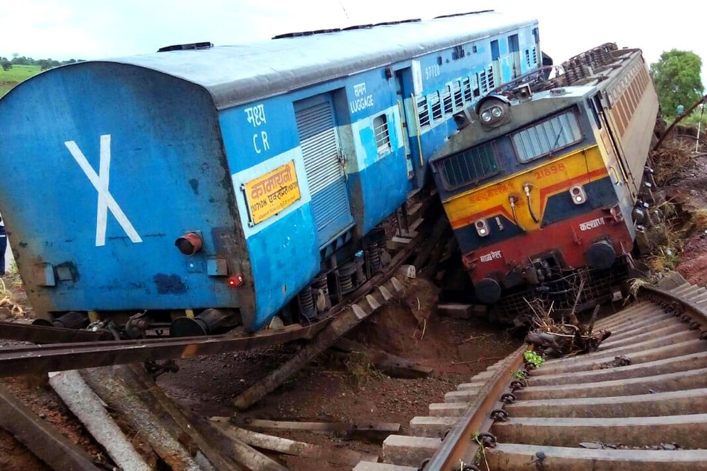 Two passenger trains lay next to each other following a derailment after they were hit by flash floods on a bridge outside the town of Harda in Madhya Pradesh state. Photo: AFP