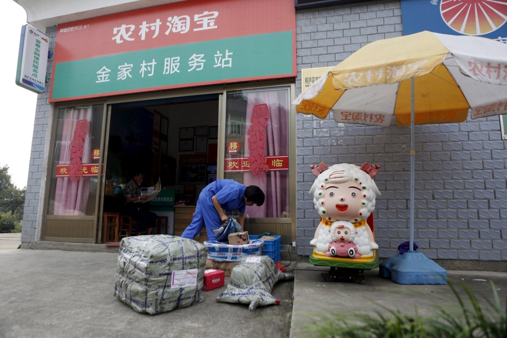 A customer checks on a parcel at an Alibaba rural service centre in a Chinese village. Photo: Reuters