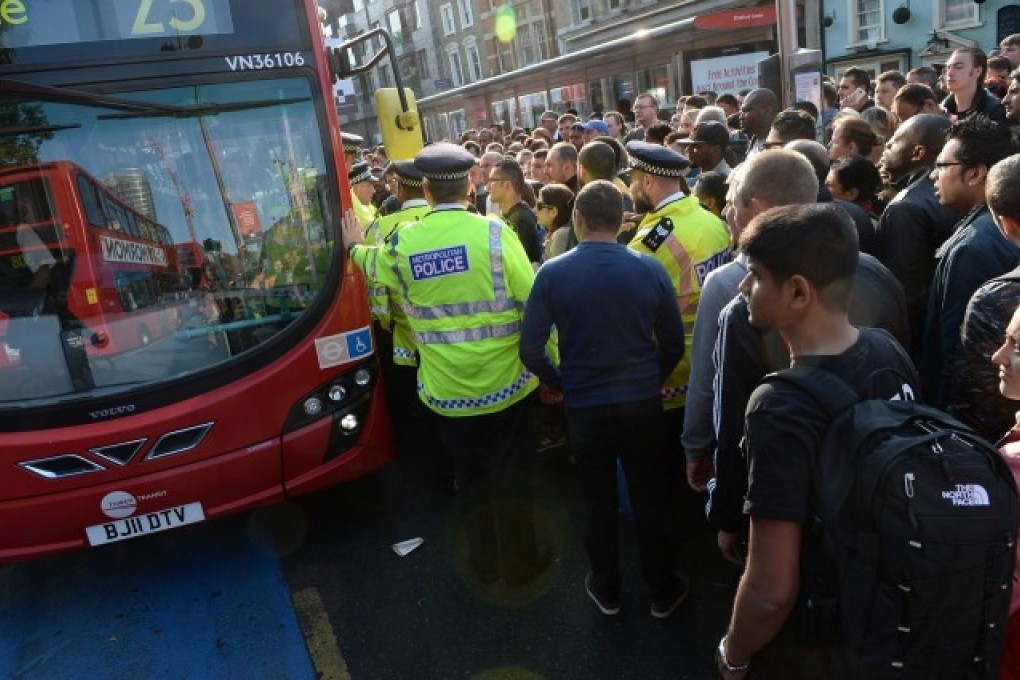 Police try to maintain order amid a crush for buses in Stratford after the start of the strike on Wednesday. Photo: AP