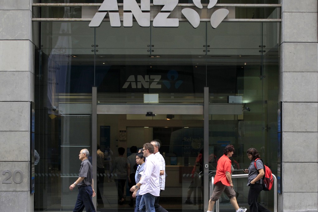 Pedestrians walk past an ANZ bank branch as the group said it will raise A$3 billion (US$2.2 billion) in a share sale to boost capital ratios in the wake of tougher regulatory requirements. Photo: AP