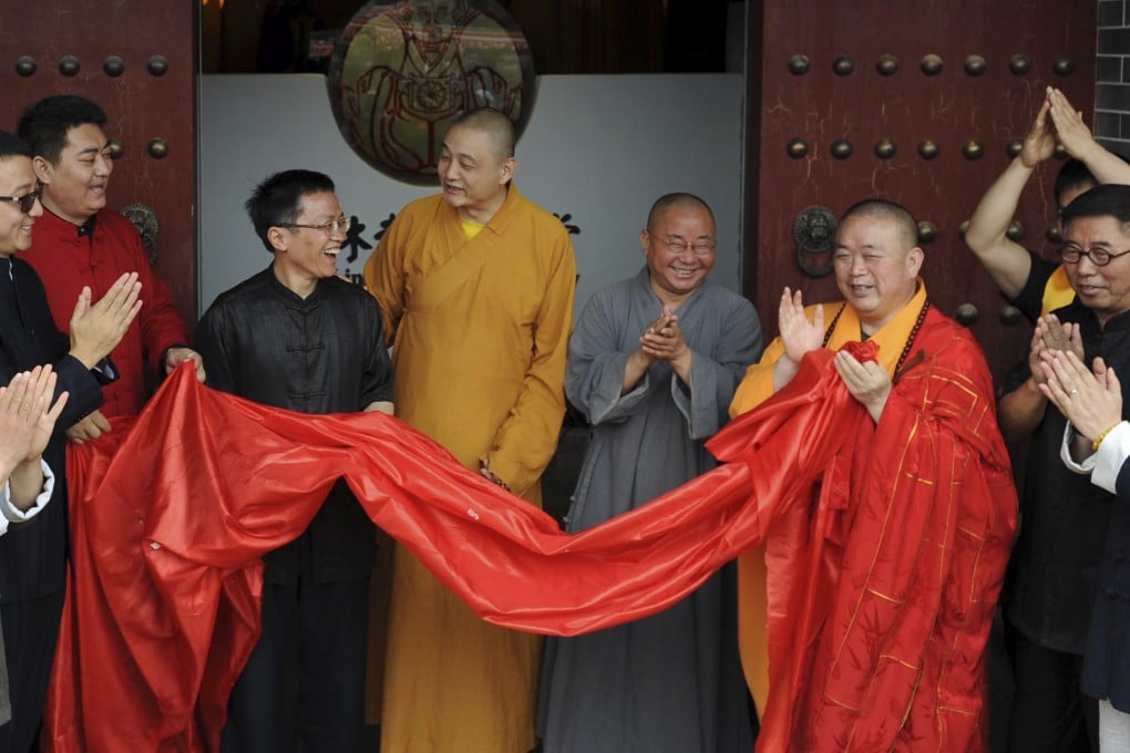 Shi Yongxin, third from right in yellow and red robes, abbot of the Shaolin Temple, attends the opening ceremony of an urban zen center named Shaolin Chan Hall in Xian. Photo: AP