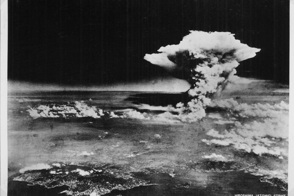 An atomic cloud billows above Hiroshima after the explosion.