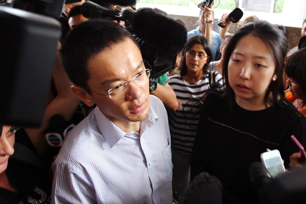 A representative from Malaysia Airlines speaks to relatives of the missing gathered outside the company's offices in Beijing on Thursday morning. Photo: Simon Song