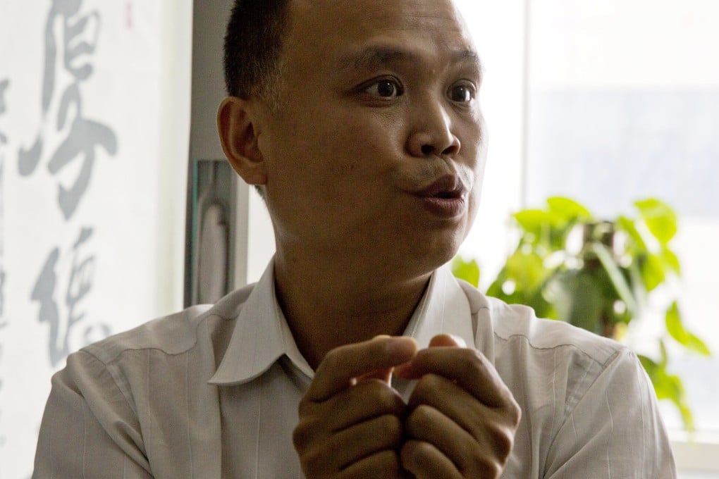 Lawyer Yu Wensheng shows how death row prisoners are handcuffed 24 hours a day, in an interview at his office on July 23 in Beijing. Photo: AP
