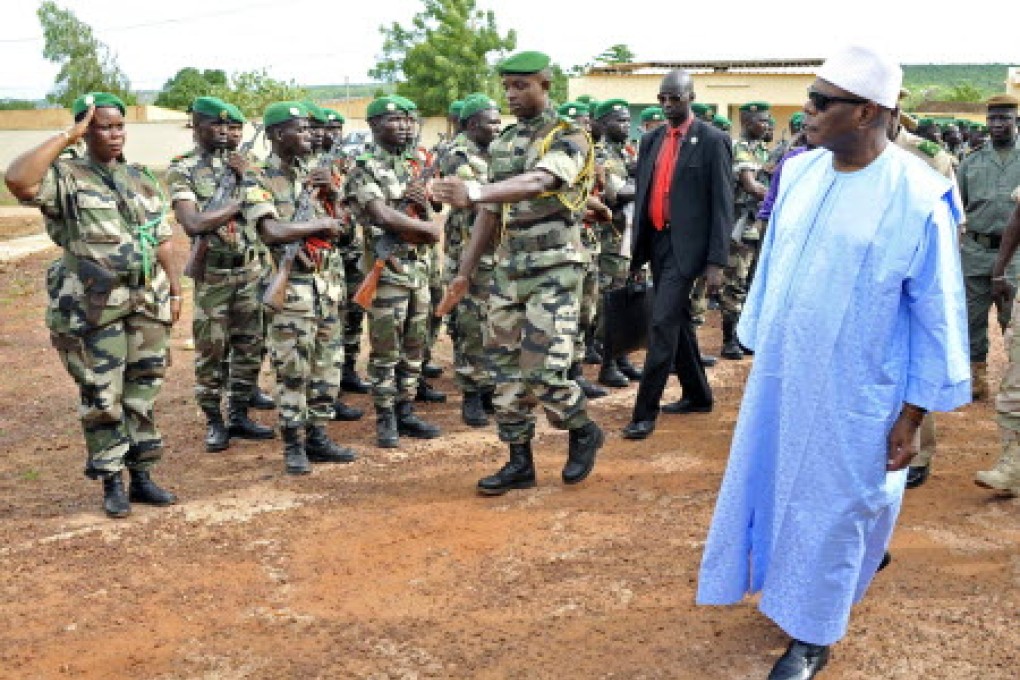 Mali's President Ibrahim Boubacar Keita reviews troops in Kati, near Bamako, this week. Gunmen have stormed a hotel in central Mali trying to take hostages. Photo: AFP