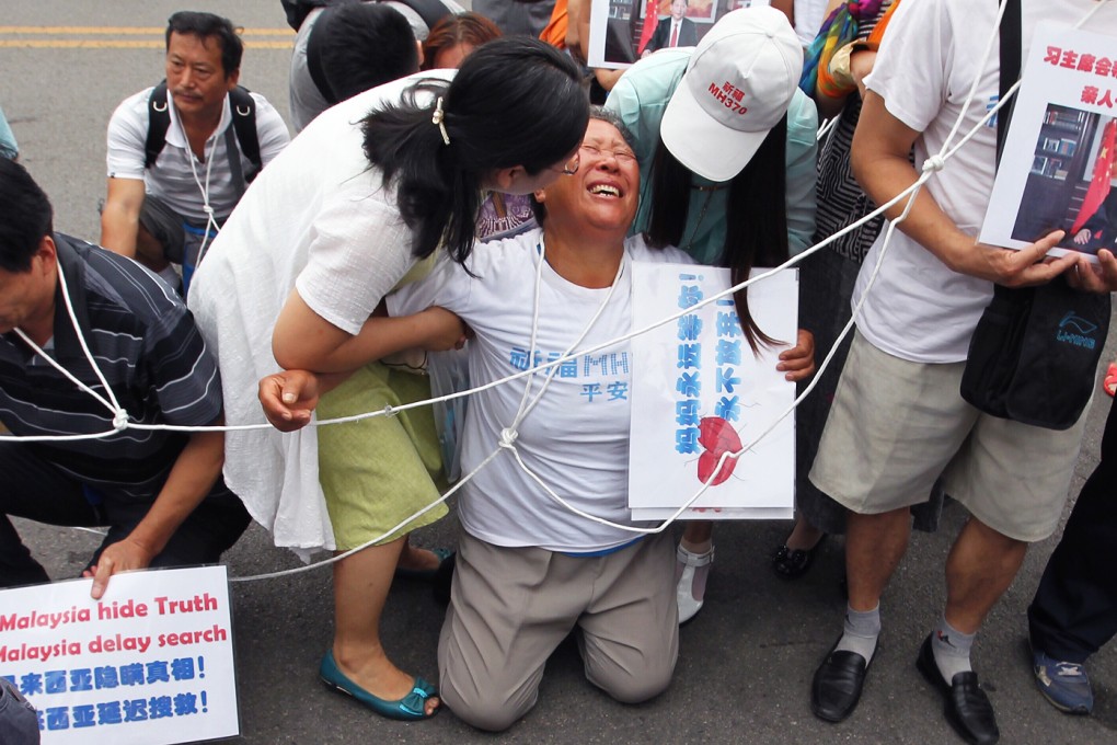 Relatives of MH370 protest before a scheduled meeting with Malaysia Airlines in Beijing on August 7 morning. Photo: Simon Song