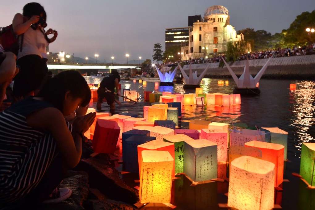 Tens of thousands gathered for peace ceremonies and floated paper lanterns on the Motoyasu River in front of the Atomic Bomb Dome (background) on the 70th anniversary of the nuclear bomb dropping on Hiroshima. Photo: AFP