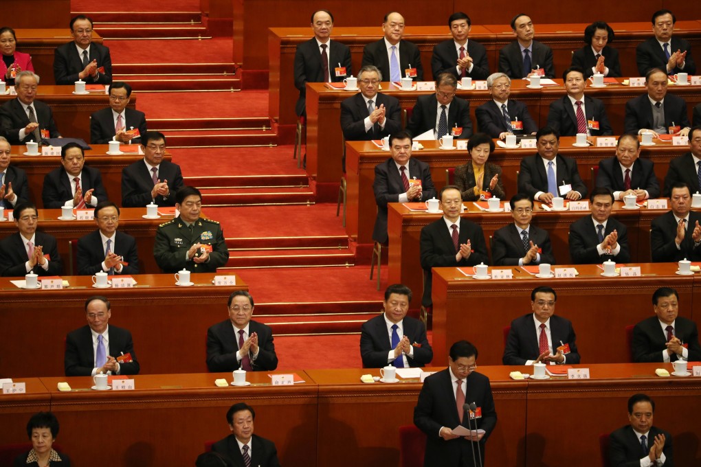 Chinese President Xi Jinping (2nd row, centre) and delegates clap during the closing session of the 12th National People's Congress. The Communist Party is trying to shore up its image and root out graft, which has flourished through personal networks. Photo: EPA